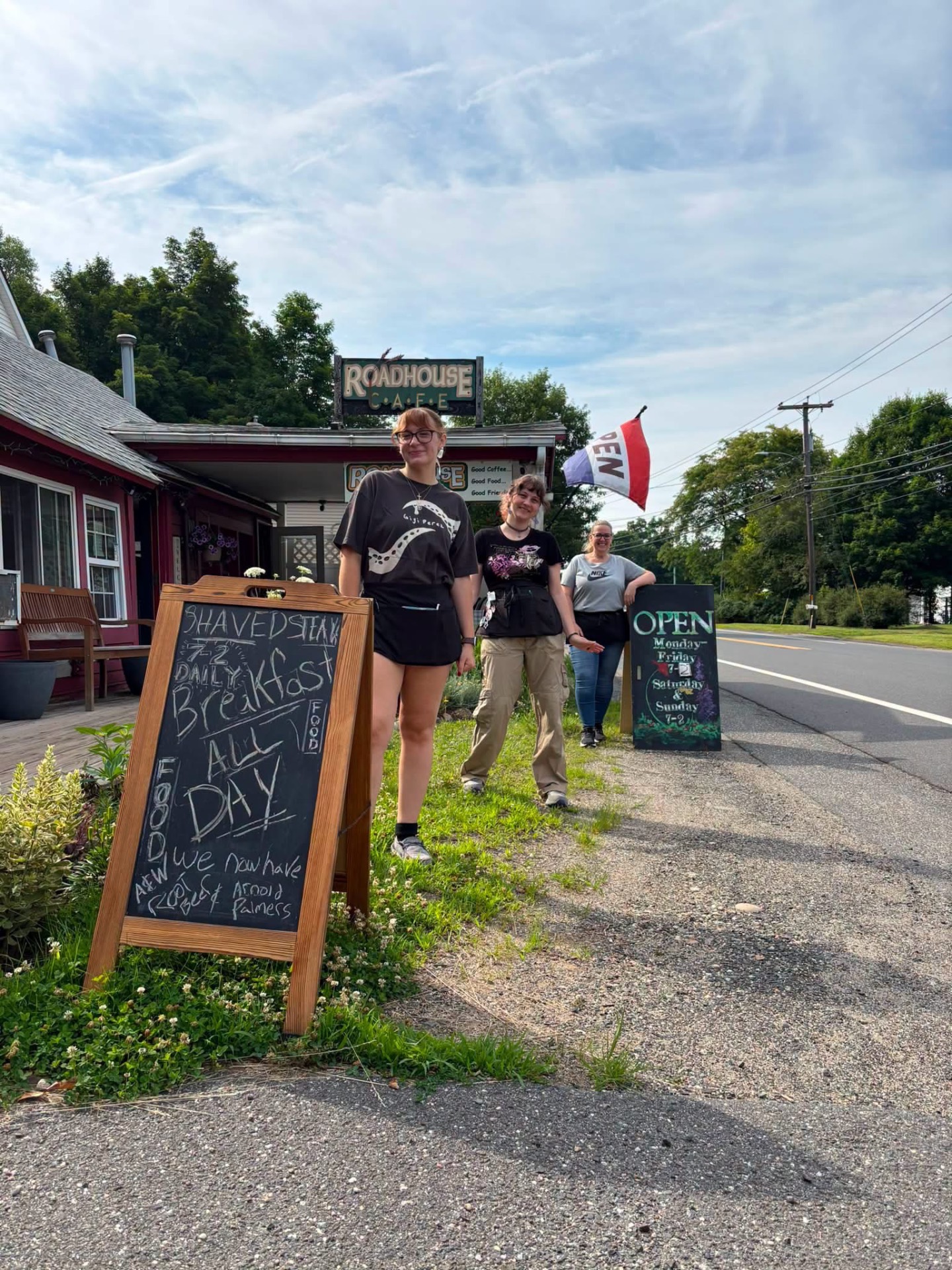 Roadhouse Cafe staff outside with a Breakfast All Day chalkboard