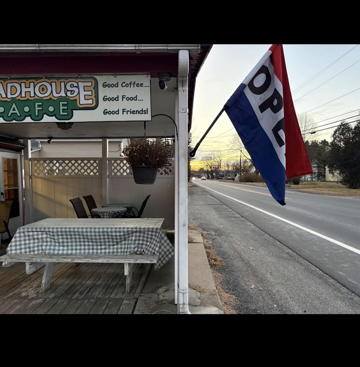 Covered porch seating with checkered tablecloths at Roadhouse Cafe